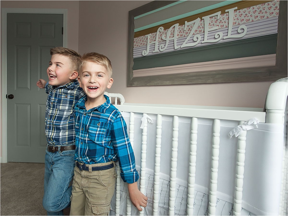 Big brothers standing in newborn nursery during an in home lifestyle maternity photography session in Canton, GA