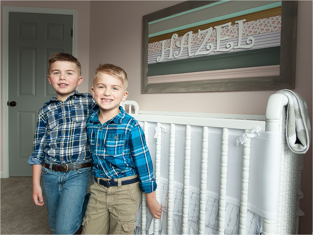 Big brothers standing in newborn nursery during an in home lifestyle maternity photography session in Canton, GA