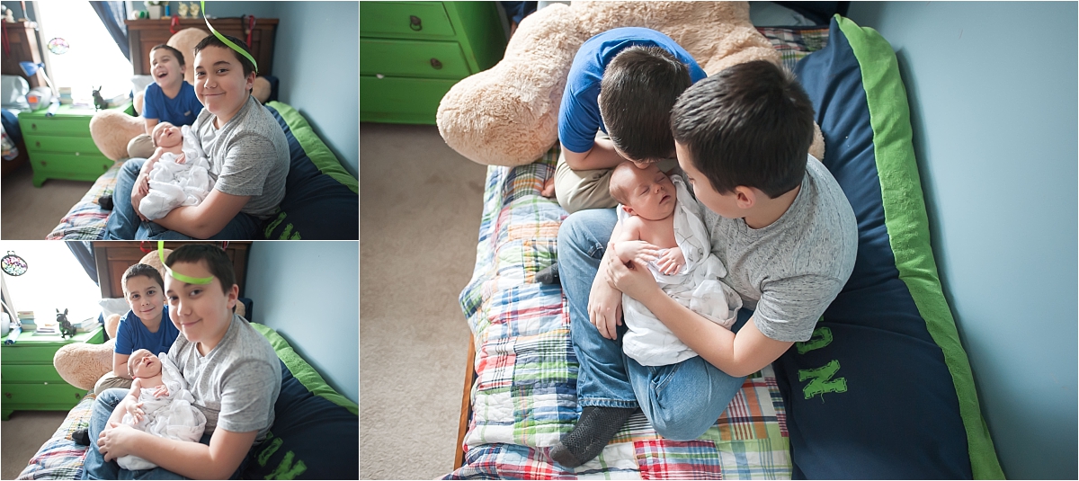 Big brothers holding newborn little brother during newborn photography session in Canton GA
