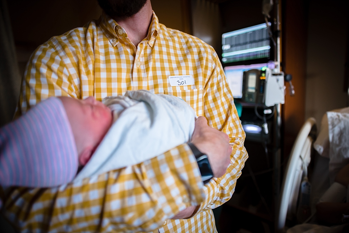 Dad holding newborn baby after birth during an Atlanta birth photography session at Kennestone Hospital in Metro Atlanta
