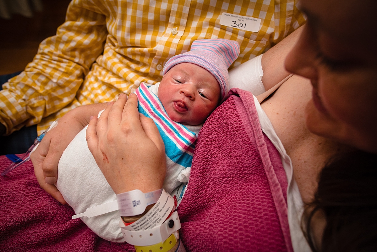 Mom holding swaddled newborn after birth during an Atlanta birth photography session at Kennestone Labor and Delivery in Metro Atlanta