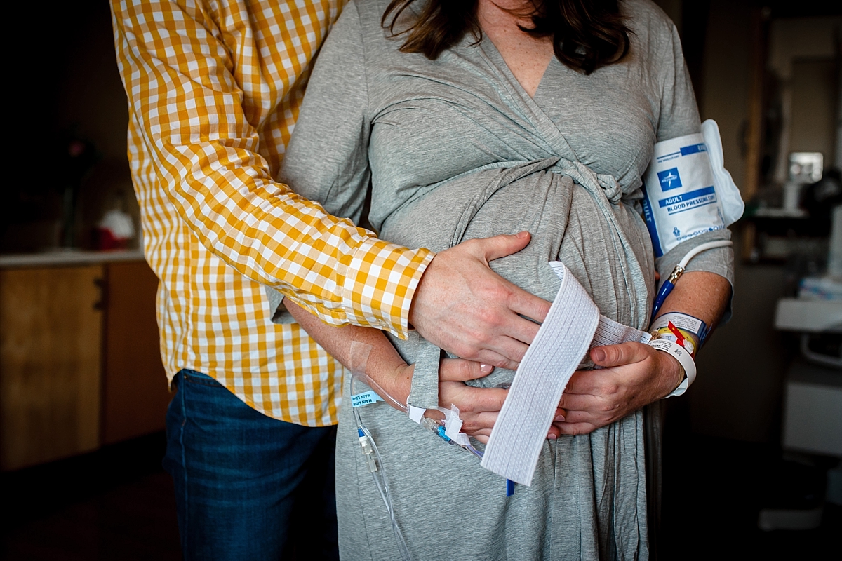 Birth partner supporting laboring mother during an Atlanta birth photography session at Kennestone Hospital in Metro Atlanta