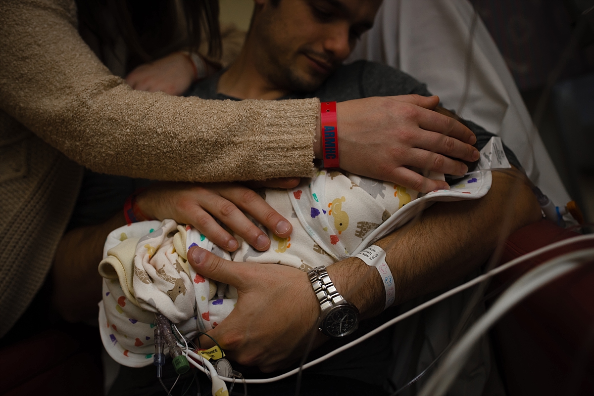 Parents holding swaddled newborn during his Atlanta NICU Fresh 48 photography session at CHOA by Atlanta birth photographer Amber Watson