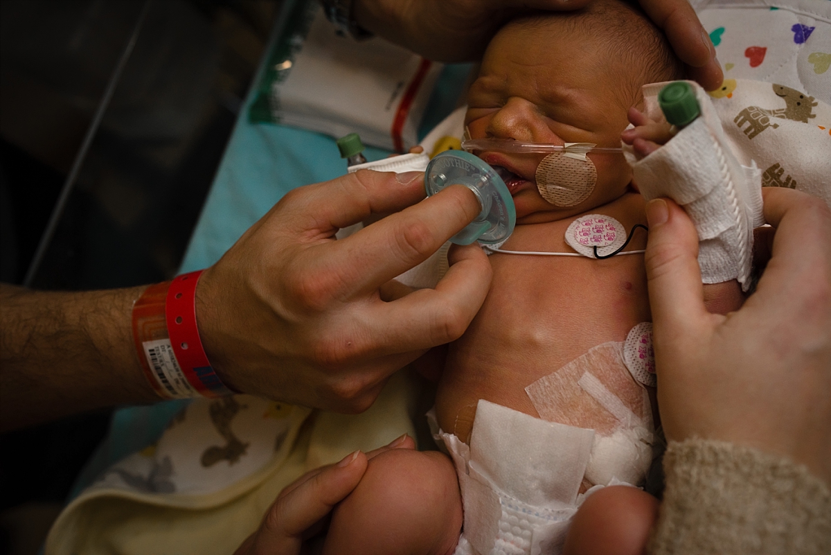 Unswaddled newborn during his Atlanta NICU Fresh 48 photography session at CHOA by Atlanta birth photographer Amber Watson