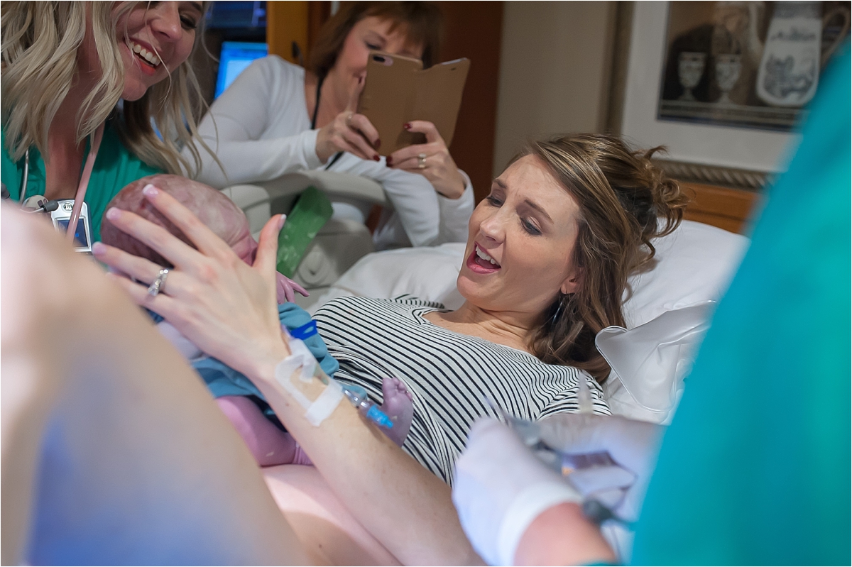 Mother smiling at newborn after birth at Kennestone Labor and Delivery in Marietta GA