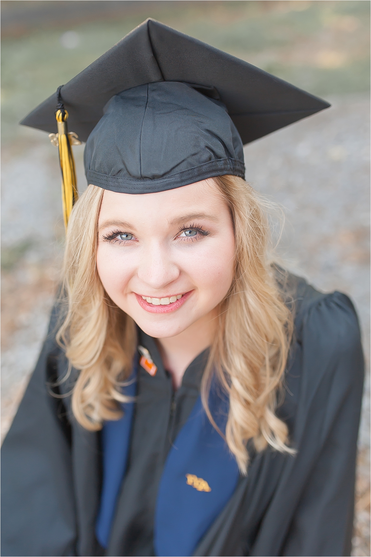 Beautiful senior picture of a graduating senior in her high school graduation cap and gown during her senior portrait photography session