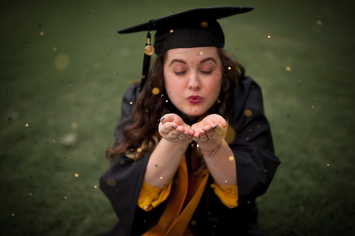 Portrait of a Kennesaw State University graduate celebrating with glitter during her KSU senior portrait photography session by Kennesaw senior photographer Amber Watson